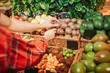 © estradaanton - Young couple in grocery store. They reach hand to exotic meal or food. People touch it. Cut view.