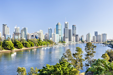 Huge city with tall buildings among green tress