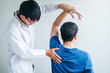 © joyfotoliakid - Physical Doctor consulting with patient About Shoulder muscule pain problems Physical therapy diagnosing concept