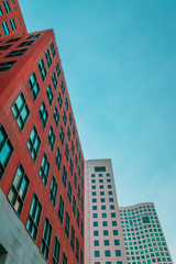 Wall Mural - Low angle view of two corporate buildings and a hotel  on blue sky