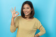 © suriya - Beautiful asian woman smiling with hand ok sign on a white isolated background