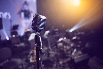 stylish 50s or 60s retro rock microphone on an empty venue stage. Vintage mic at a live band show