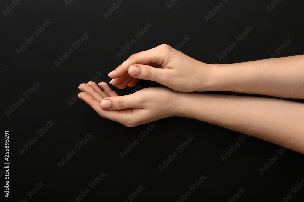 Female hands with manicure on dark background