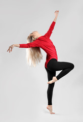 Poster - Young female dancer on light background