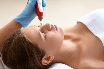 Young woman undergoing procedure of bb glow treatment in beauty salon