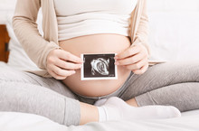 Pregnant Woman Holding Ultrasound Photo Near Belly