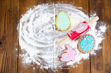 Homemade cookies in form letters EASTER and eggs on old wooden backgroun.