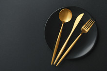 Gold Cutlery Set On Black Background