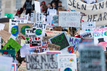 people with banners protest as part of a climate change march