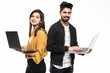 © F8  \ Suport Ukraine - Portrait of a young indian couple holding laptops computer while standing isolated over gray wall background