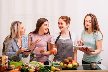 Cooking housewives. Healthy recipes. Dieting with food expert. Excited females discussing organic nutrition.