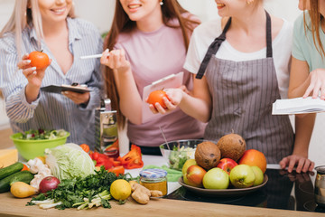 Culinary courses. Communication and food education. Women choosing organic vegetables and learning healthy diet recipes.