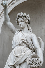 Wall Mural - Statue of sensual busty and puffy renaissance era woman in circlet of flowers, Potsdam, Germany, details, closeup