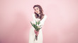 © puhimec - Young girl with tulips on a colored background