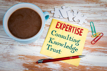 Wall Mural - Expertise concept. Text on a napkin with a cup of coffee