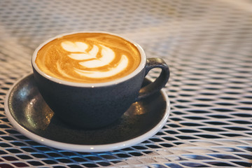 Cup of coffee on the table and drink into energy to start the day.