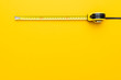 tape measure on the yellow background with copy space