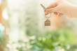 © sommart - House model and key in home insurance broker agent ‘s hand or in salesman person. Real estate agent offer house, property insurance and security, affordable housing concepts