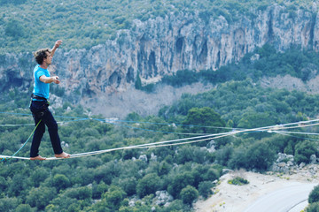 Man balancing on the rope concept of risk taking and challenge.