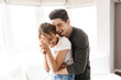 © Drobot Dean - Portrait of excited couple laughing and hugging together while having fun at home