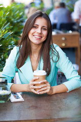 Canvas Print - A woman relaxing with a drink coffee