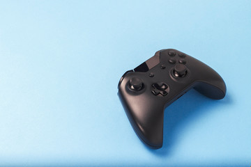 Gamepad on a blue background. Concept of the game in the console or computer. Rest after work. Cybersport. Flat lay, top view