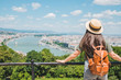 © phpetrunina14 - young stylish woman looking at panoramic view of budapest city