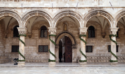 Wall Mural - Columns and exterior of the Duke's Palace (Knezev dvor) decorated with Advent wreaths in Dubrovnik, Croatia 