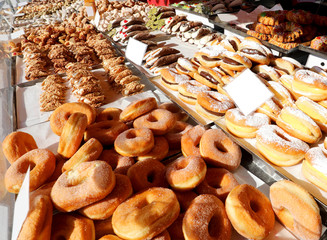 Wall Mural - many fried doughnut and more pastries with sugar for sale at kio