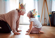 canvas print picture - A portrait of small girl with grandmother having fun at home.