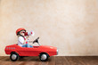 © Sunny studio - Funny kid driving toy car at home