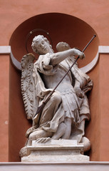 Wall Mural - Saint Michael statue on the portal of St. Barbabas Church, Italy