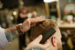© Natalie Faye - Close up of barber styling man's hair