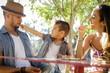 © Natalie Faye - Young boy feeds snack to father