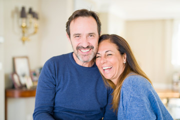 Romantic middle age couple sitting together at home