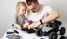 Family Time: Dad And Daughter Repair The Rc Radio Controlled Buggy Car Model And Lead A Video Blog.