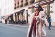 © teksomolika - young beautiful stylish woman walking in pink coat