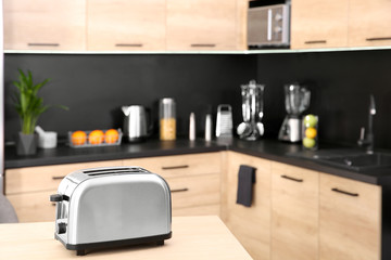 Sticker - Modern toaster on table in kitchen, selective focus