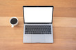 © Farknot Architect - Top view mockup image of laptop with blank white desktop screen with coffee cup on wooden table