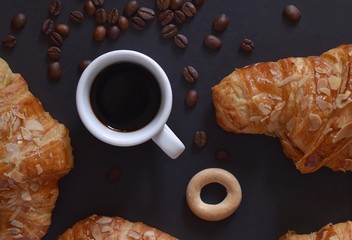 Wall Mural - A Cup of aromatic coffee on the background of beautiful croissants. Coffee mood 