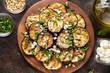 © maria_lapina - Fried eggplant with feta, pine nuts, fresh herbs (cilantro, parsley) and olive oil. Tasty vegetable snack, summer, spring food, picnic