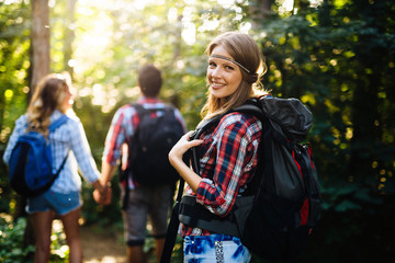 Wall Mural - group of backpacking hikers going for forest trekking