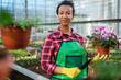 © Nejron Photo - Black woman working in a botanical garden
