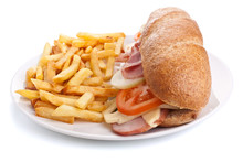 Sub Bran Baguette  Sandwich With Ham, Cheese, Lettuce And Tomatoes On A Plate With French Fries Closeup