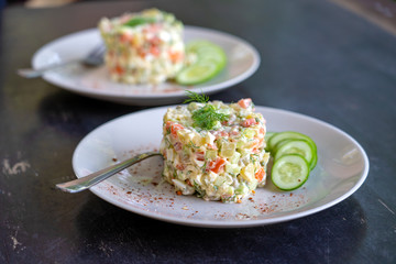 Healthy homemade russian traditional salad olivier ready to eat, close up