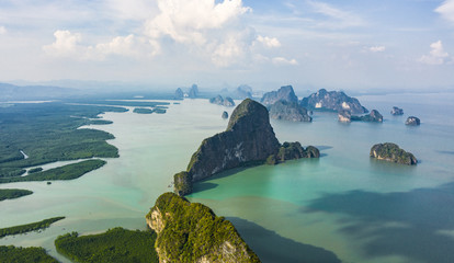 Wall Mural - View from above, aerial view of the beautiful Phang Nga Bay (Ao Phang Nga National Park) with the sheer limestone karsts that jut vertically out of the emerald-green water, Thailand.