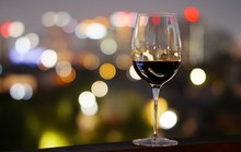 A Glass Of Wine In A Restaurant  Dinning Room Or Rooftop Bar, With Bokeh Background Of The City Light, Good View And Romantic Scene, For Valentine Dating Or Celebrate Special Day,with Copy Space,