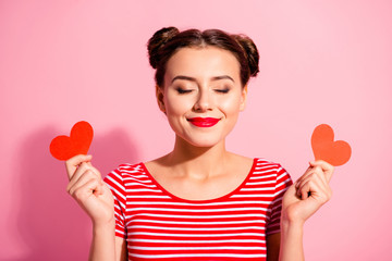 Poster - Close-up portrait of her she nice cute charming attractive glamorous fascinating peaceful girl wearing striped t-shirt holding in hands small little hearts isolated over pink pastel background