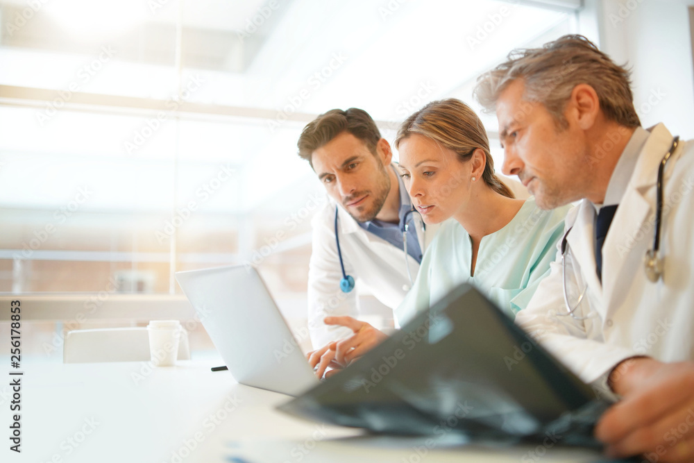 Doctors and nurse going over patient's results in hospital