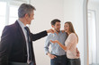 © goodluz - Estate agent handing over keys to happy new home owners